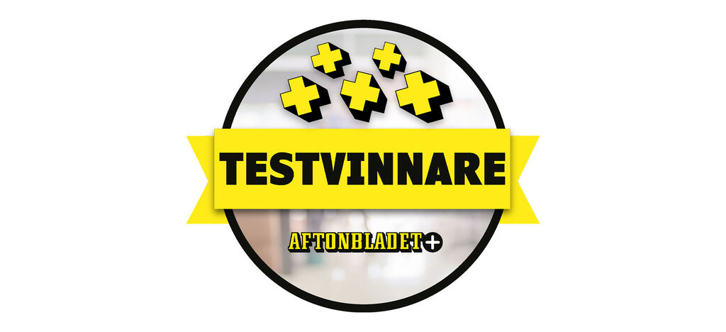 Logo med sort ramme og gul skrift, viser "TESTVINNARE", i midten et positivt plustegn